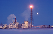Full moon & a flare at Endicott Oil Production Island. Prudhoe Bay on the North Slope. Alaska. USA. 1989