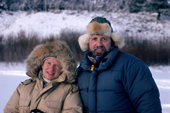 Bryan and Cherry on location in Montana, wearing fur trimmed hoods on their parkas. Montana. USA.