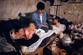 An Inuit family relaxes inside a hunters hut on Baffin Island. Nunavut, Canada. 1992