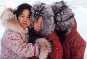 Inuit girls in fur hoods together in the street. Ulukhaktok, Holman Island, NWT, Canada. 1991