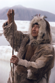 Inuk, Kavavow Kiguktak, fixes a sealskin line on his harpoon. Grise Fjord, Ellesmere Is. Canada. 1994