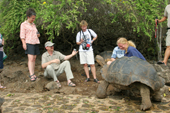 Visitors watch Giant Tortoises eating at the Charles Darwin Research Station. Puerto Ayora. Santa Cruz. Galapagos