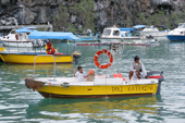 Children use a water taxi to return to their boat in Puerto Ayora harbour, Santa Cruz, The Galapagos Islands
