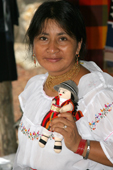Indian woman with a doll from her souvenir stall, The Primicias Farm, Santa Cruz. Galapagos.