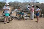 Visitors check the mail in the barrel at Post Office Bay, Floreana, Galapagos Islands.