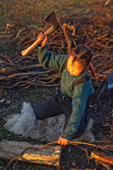 Ruslana Votgyrgina, a young Chukchi girl, using a hatchet to chop firewood at a reindeer herders' summer camp. Iultinsky District, Chukotka, Siberia, Russia