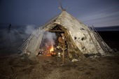 A ritual fire burns at the entrance to a Yaranga (tent) as the Chukchi herders prepare for the start of the 'Festival of the Young Reindeer' at a Chukchi herders' summer camp. Iultinsky District, Chukotka, Siberia, Russia.