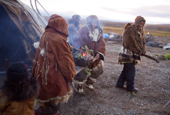 Women of the family carry a ceremonial fire to a site at the front of their Yaranga (tent) during the Chukchi 'Festival of the Young Reindeer' held at a herders' summer camp. Iultinsky District, Chukotka, Siberia, Russia.