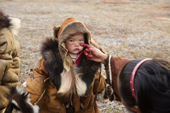 18 month old Rima Votgyrina, a Chukchi girl, has her family's ancestral clan mark painted in reindeer blood on her face, a ritual during the Chukchi 'Festival of the Young Reindeer.' Iultinsky District, Chukotka, Siberia, Russia.