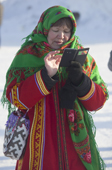 A Mansi woman wearing traditional dress using her mobile phone in Saranpaul. Khanty Mansiysk, Northwest Siberia, Russia