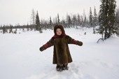 Yana Nogo, a 2 year old Komi girl, plays outside in the snow at her family's winter camp. Yamal, Northwest Siberia, Russia