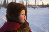 Yana Nogo, a 2 year old Komi girl, outside at her family's winter camp. Yamal, Northwest Siberia, Russia