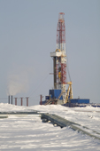 A derrick and pipes in the Yorharovo gas fields north of Noviy Urengoi. Yamal, Western Siberia, Russia