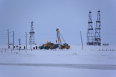 Gas drilling derricks & workers at Sabetta in the Tambey gas field. Yamal Peninsula, Western Siberia, Russia