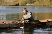 On an autumn day, Gennadiy Kubolev, a Selkup man, checks a fishing net from his 'Anty' (traditional dugout boat) on the River Shirta. Krasnoselkup, Yamal, Western Siberia, Russia
