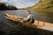On an autumn day, Gennadiy Kubolev, a Selkup man, checks a fishing net from his 'Anty' (traditional dugout boat) on the River Shirta. Krasnoselkup, Yamal, Western Siberia, Russia