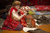 Marina Valeeva, a Komi woman, prepares to cut a pattern from a reindeer skin on the floor of her tent, which she will use to make a coat for her daughter. Yamal, Western Siberia, Russia