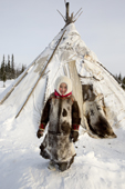 Anastasia Valeeva, a 7 year old Komi girl, outside her family's reindeer skin tent at a winter herders'camp in the Yamal. Western Siberia, Russia