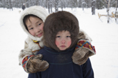 Albina Valeeva, a young Komi girl (left),playing outside with her brother, Matvey, at their family's winter camp in the forest. Priuralsky District, Yamal, NW Siberia.