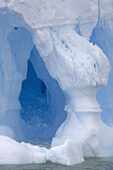 An iceberg with ice arch and column, sculpted by the sea. Antarctica.