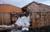 Mawson's Hut, filled with snow, in Commonwealth Bay, Cape Denison. Adelie Coast. Antarctica.