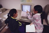 Inuit children learning to use a computer at school in Igloolik, Nunavut, Canada. 1990