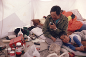 Niaqutsiaq, chats to other Inuit hunters on the radio from his summer camp. Nunavut, Canada. 1992