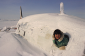 Inuit boy at the window of a crashed plane on the Melville Peninsula. Nunavut. Canadian Arctic. 1999