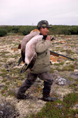 James (Jimmy) Rupert, a Cree hunter carrying geese that he has shot in the autumn. James Bay. Quebec, Canada. 1988