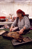 A Cree woman, Elizabeth Brien, preparing a beaver for a family feast. Northern Quebec, Canada. 1988