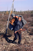 Abel Brien, a Cree hunter, carries his grandson while portaging between two lakes. The Cree. Quebec. Canada. 1988