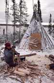 Elizabeth Brien, a Cree woman chops firewood at the family's winter camp at Lake Bourinot. Canada. 1988