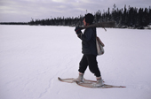 Abel Brien, a Cree hunter wearing snow shoes to aid his walking on a frozen lake. Quebec, Canada. 1988