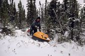 Cree hunter, Abel Brien, travels by skidoo to check his trapline. Quebec, Canada. 1988
