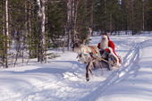 Santa Claus drives his reindeer sled through the snow. Rovaniemi. Finland. 1996