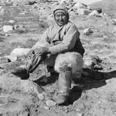 Qalaseq Duneq, an elderly inuk in traditional summer clothing, bear skin pants, sealskin boots and cotton anorak. Northwest Greenland. 1971