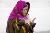 A Khanty woman using a mobile phone in Nadym. Yamal, Northwest Siberia, Russia