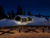 Snow covered log cabins at the Ice Hotel, Jukkasjarvi, Kiruna, Lapland, Sweden.