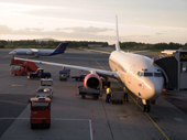 SAS Jet refuels at the Jetway at Oslo's Gardemoen Airport. Sunset, Norway.